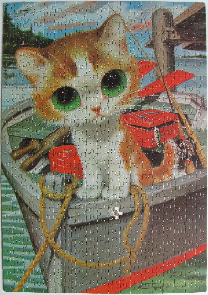 A cute orange and white kitten with large green eyes sitting in a small fishing boat.