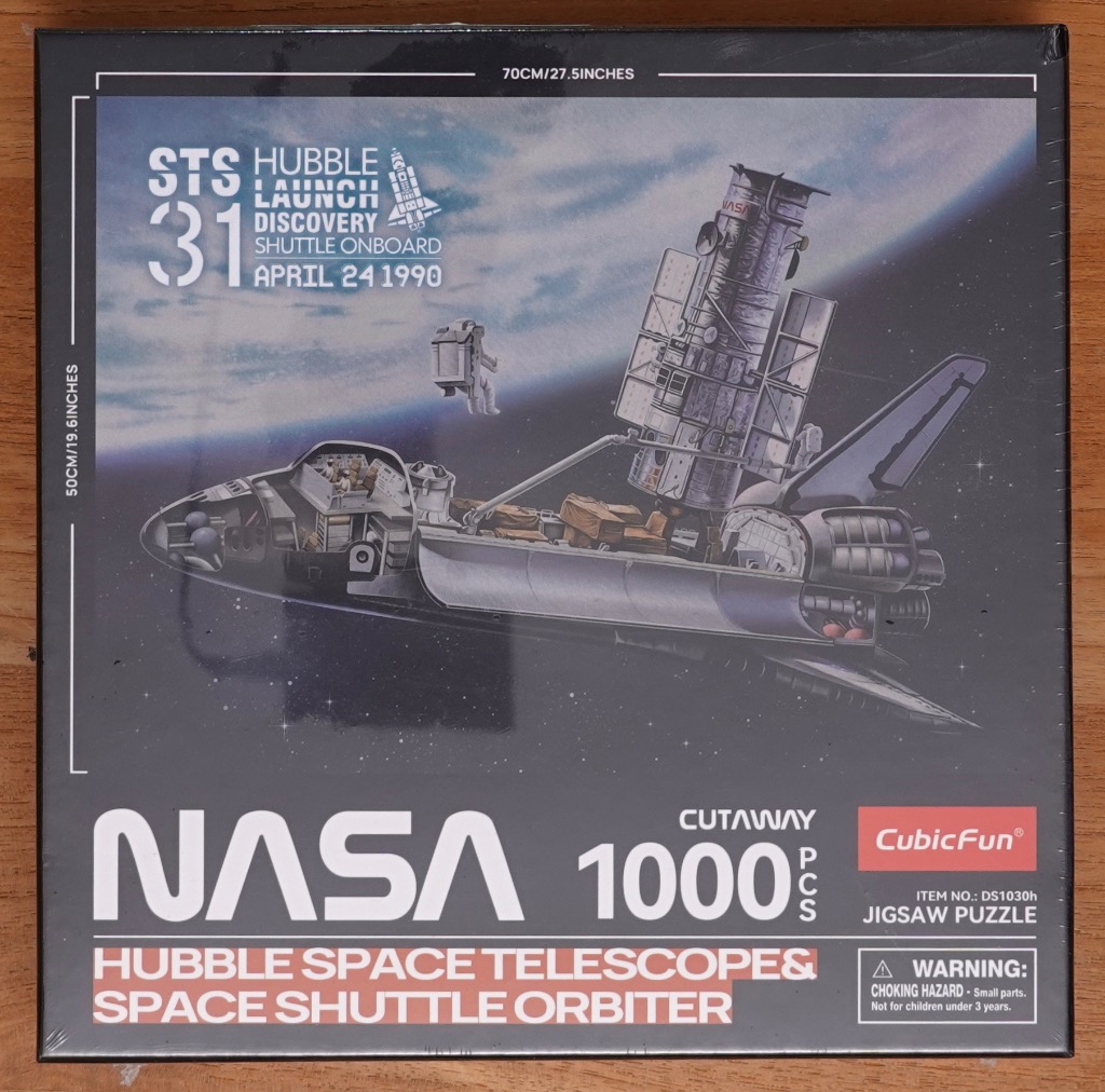 A cutaway illustration of a Space Shuttle orbiter deploying the Hubble Space Telescope in orbit above Earth.