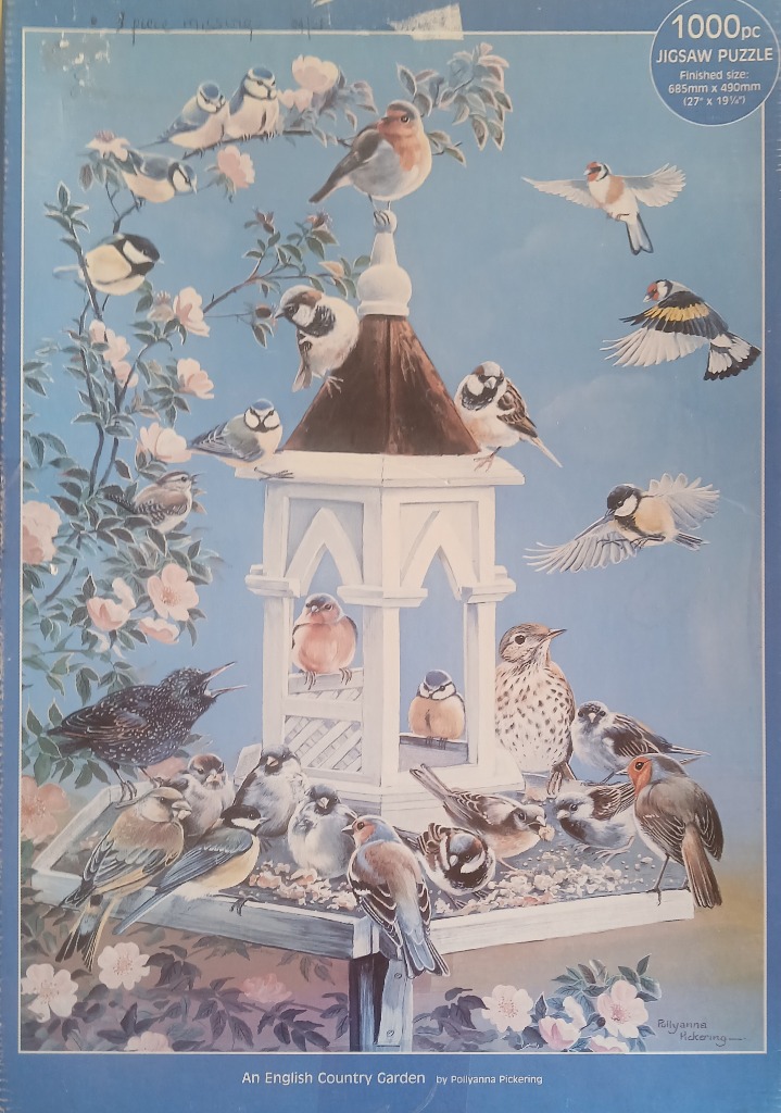 A group of various songbirds congregating around a wooden birdhouse and feeder against a pale blue background.
