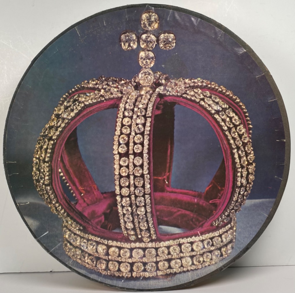 A regal, diamond-encrusted crown with red velvet lining set against a dark blue background.