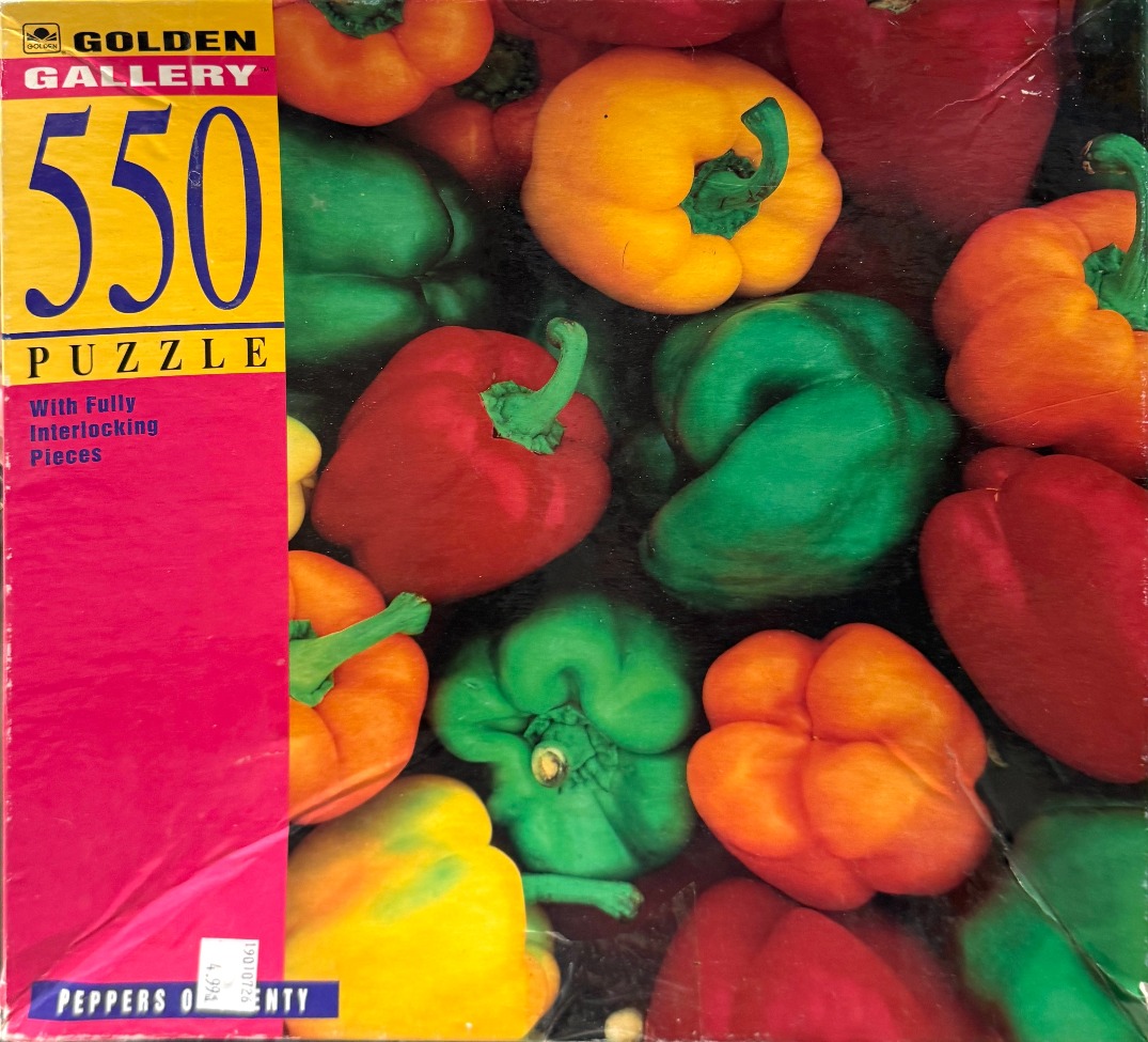 A collection of colorful bell peppers in red, yellow, orange, and green arranged closely together.