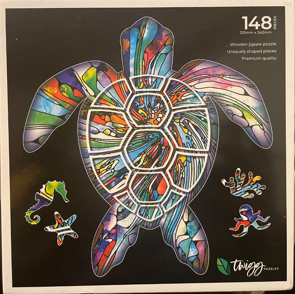 A sea turtle in a stained-glass style with vibrant, swirling colors against a solid black background.