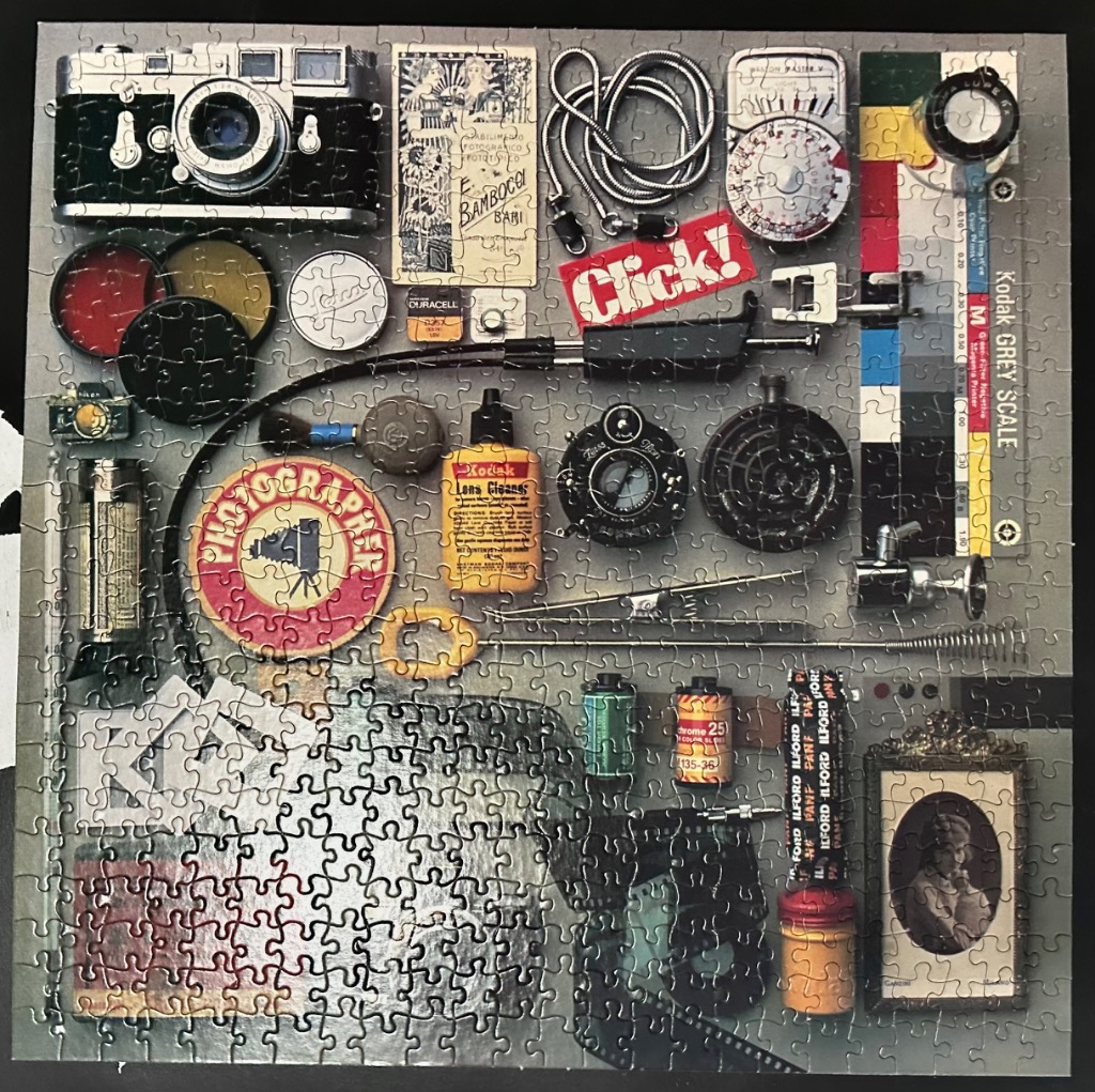 A flat-lay photograph of vintage film photography accessories and equipment.