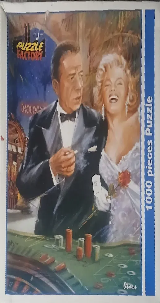 Painted portrait of Humphrey Bogart and Marilyn Monroe at a casino table with a roulette wheel and chips.