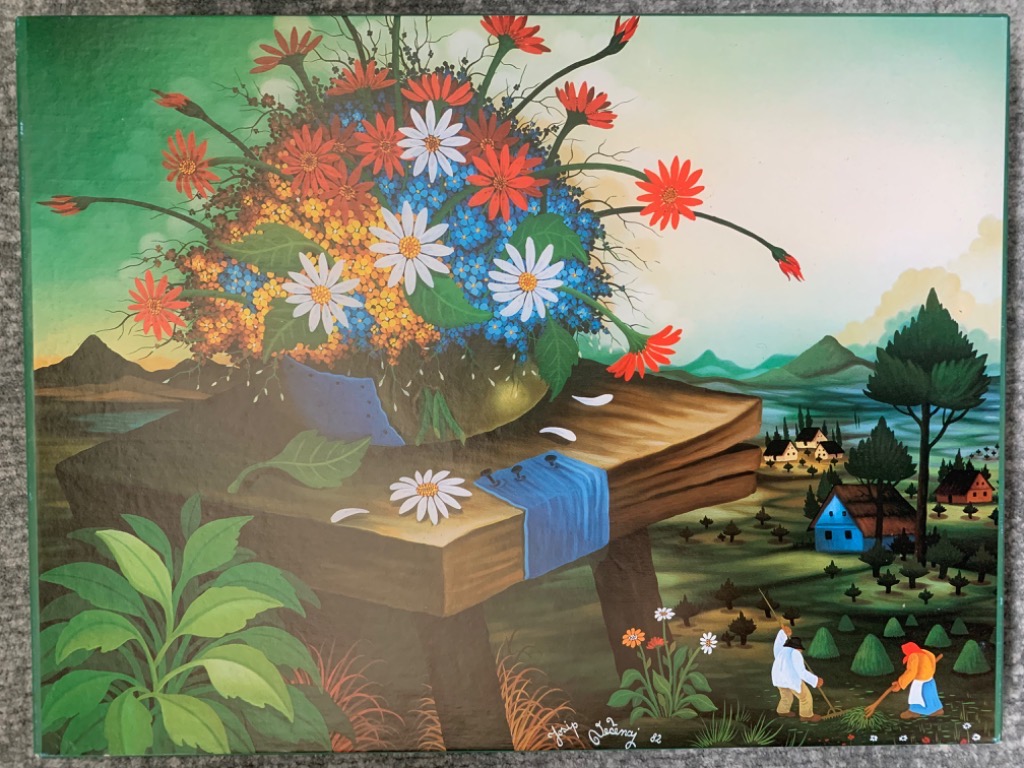Naïve art painting of a large flower arrangement on a wooden table overlooking a rural landscape with farmers.
