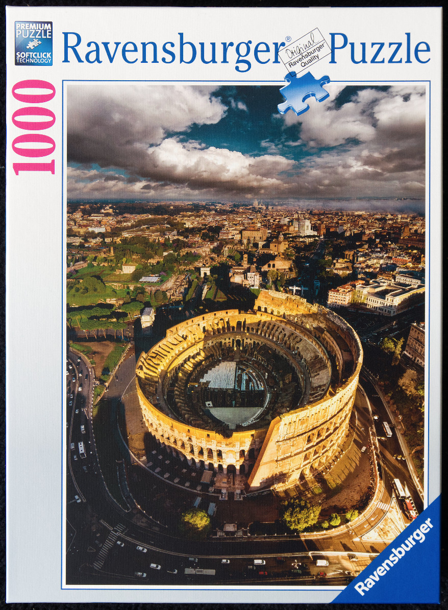 An aerial high-angle view of the Colosseum in Rome during golden hour.