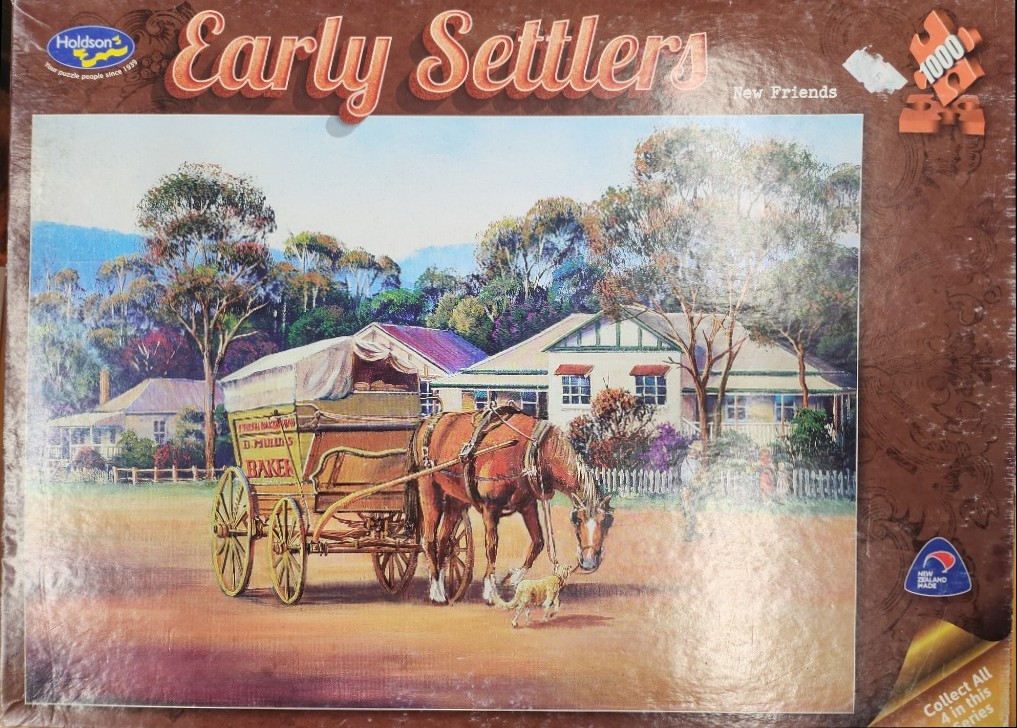 A horse-drawn bakery cart meets a small dog in front of a colonial-style house.