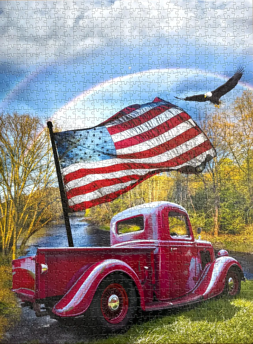A red vintage pickup truck with an American flag, bald eagle, and rainbow in a forest setting.