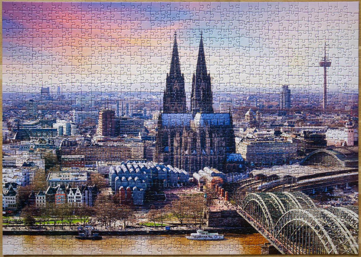Aerial view of Cologne Cathedral and Hohenzollern Bridge at sunset