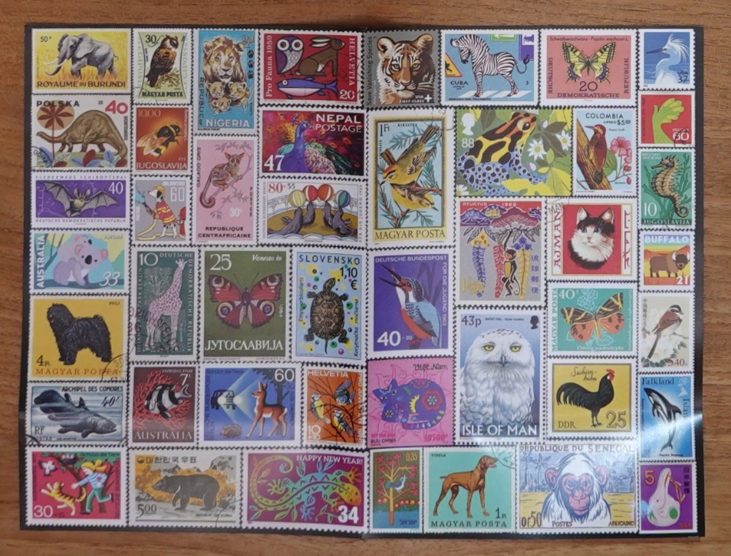 A collection of assorted vintage postage stamps featuring various animal illustrations arranged in a grid.