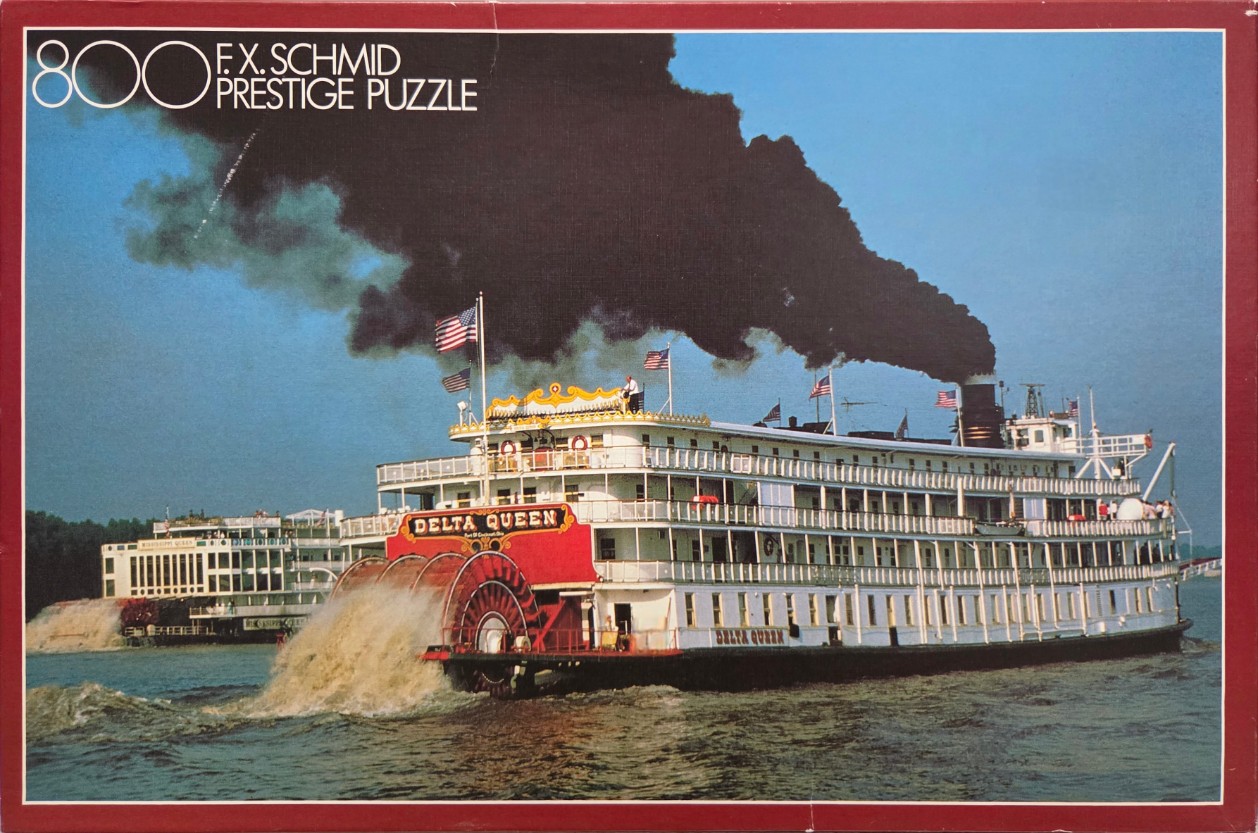 A vintage photograph of two historic paddlewheel steamboats traveling on a river under a clear blue sky.
