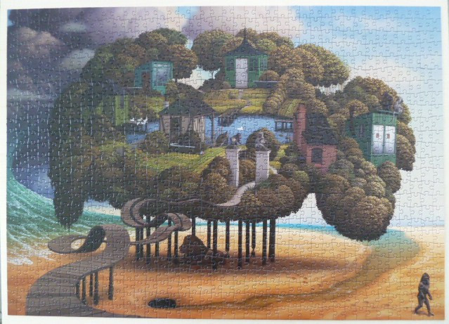 Surreal illustration of a house-filled island floating on stilts above a beach, with a lone primate figure walking below.