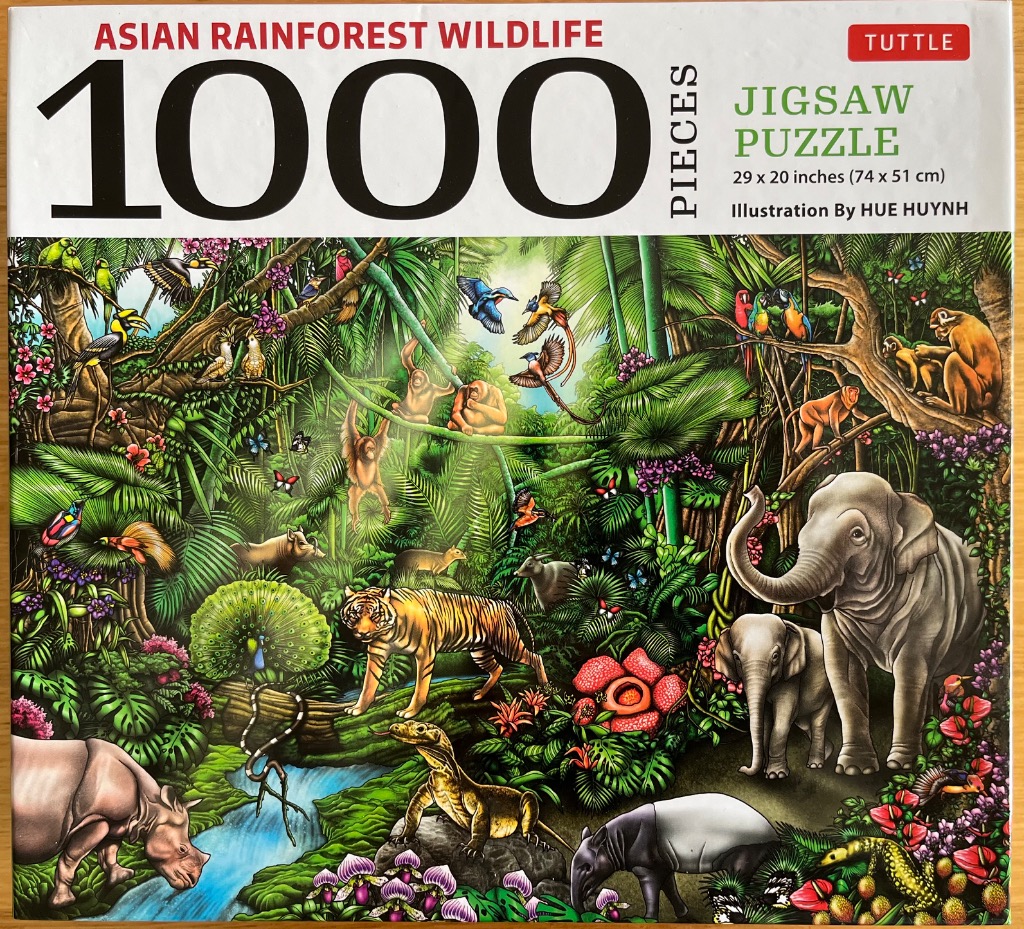 Illustration of various Asian rainforest animals including an elephant, tiger, and orangutans in a lush jungle setting.