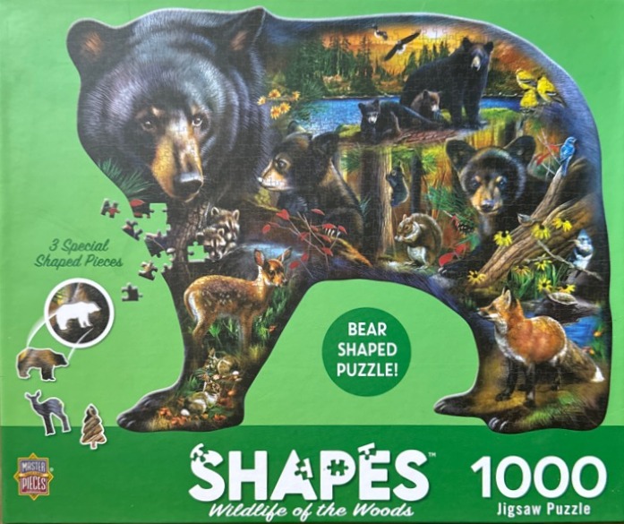 A montage of forest wildlife contained within the silhouette of a large black bear.
