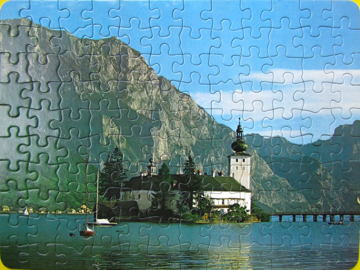 Schloss Ort castle on a lake in Austria with mountains in the background