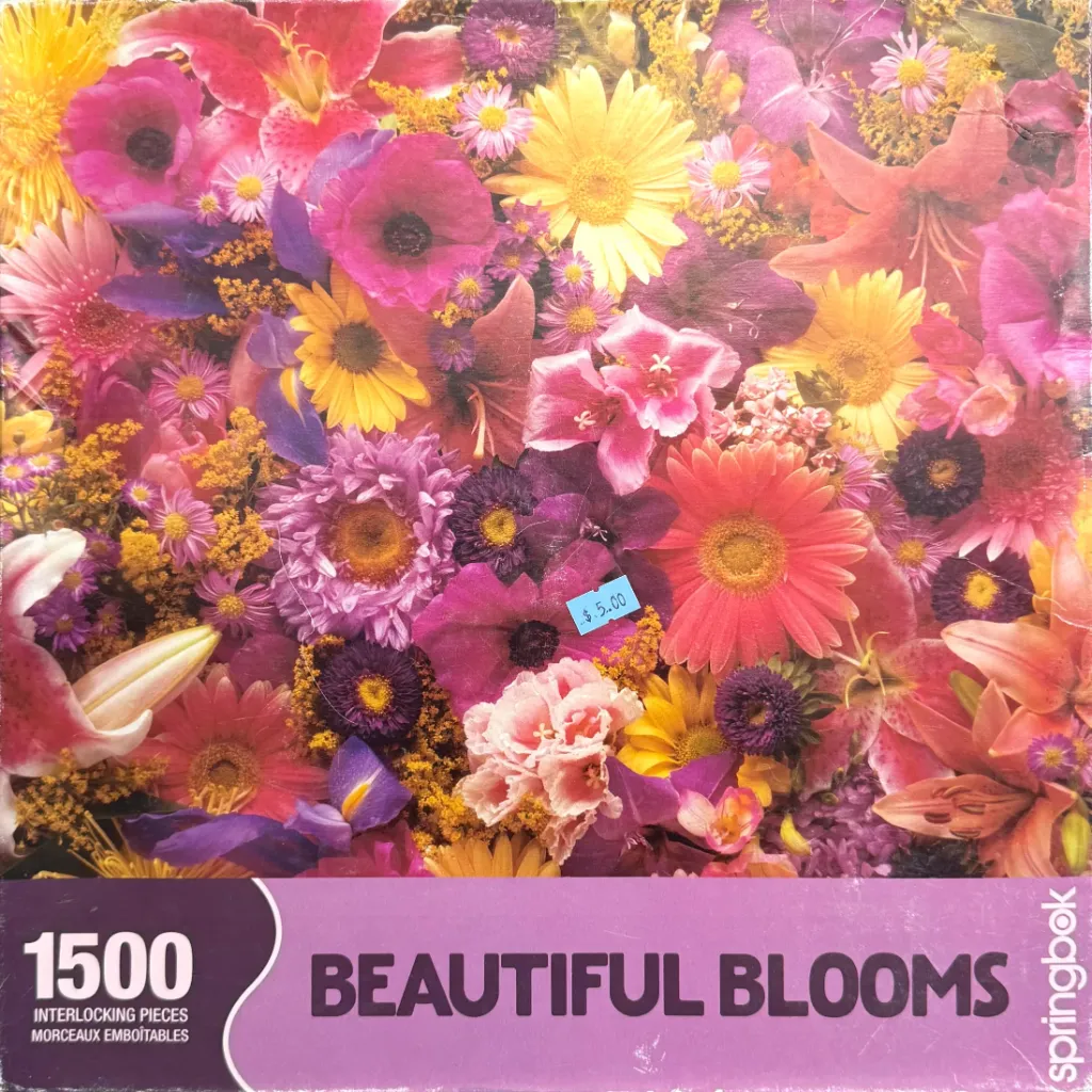 A dense, colorful collection of various blooming flowers including poppies, lilies, and daisies.