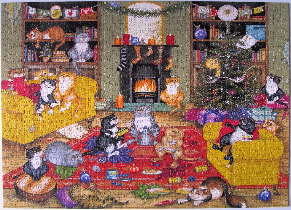 A cozy living room filled with many cats celebrating Christmas in front of a fireplace and a tree.