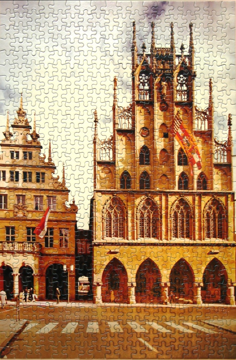 An illustration of an ornate historic Gothic-style town hall and adjacent building in a city square.