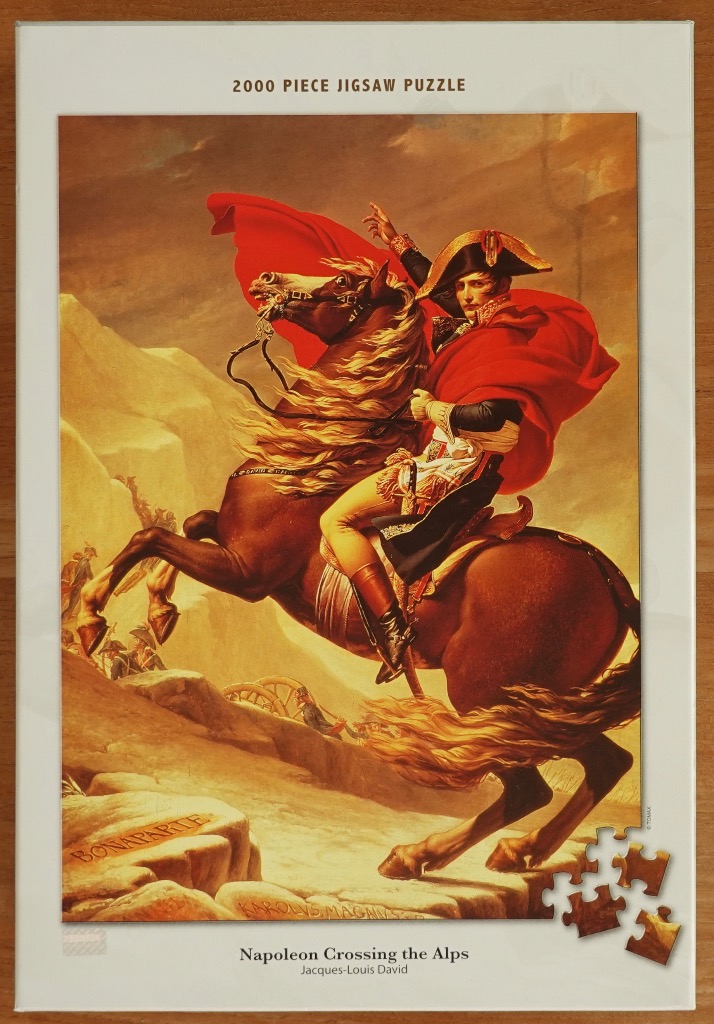 A painting of Napoleon Bonaparte riding a rearing horse across the Alps, wearing a vibrant red cape.
