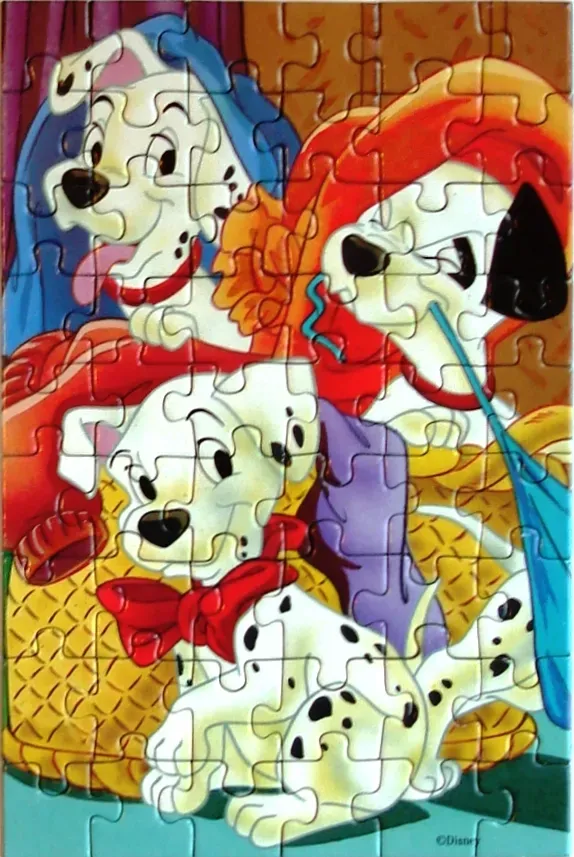 Three Dalmation puppies sitting together in a cozy indoor setting