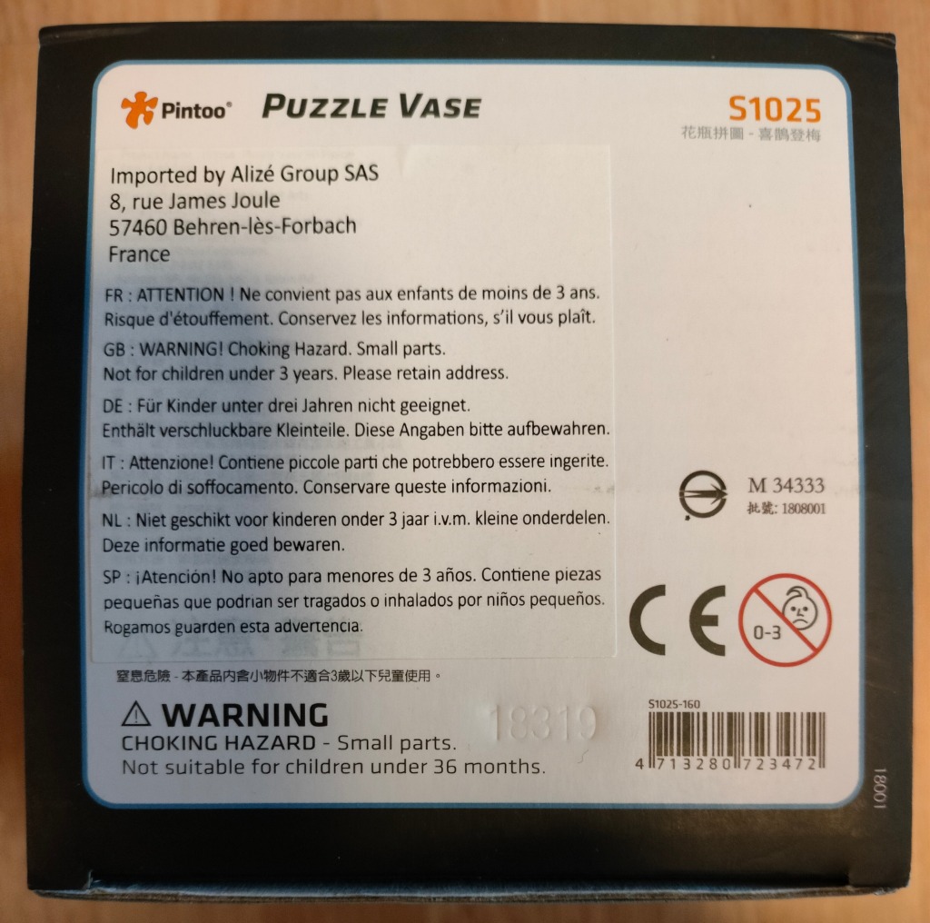 Puzzle Vase packaging with multilingual warnings and product code.