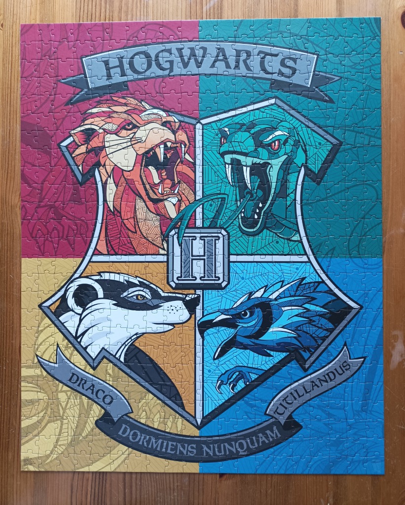 Illustration of the four Hogwarts house mascots arranged within a quartered shield crest.