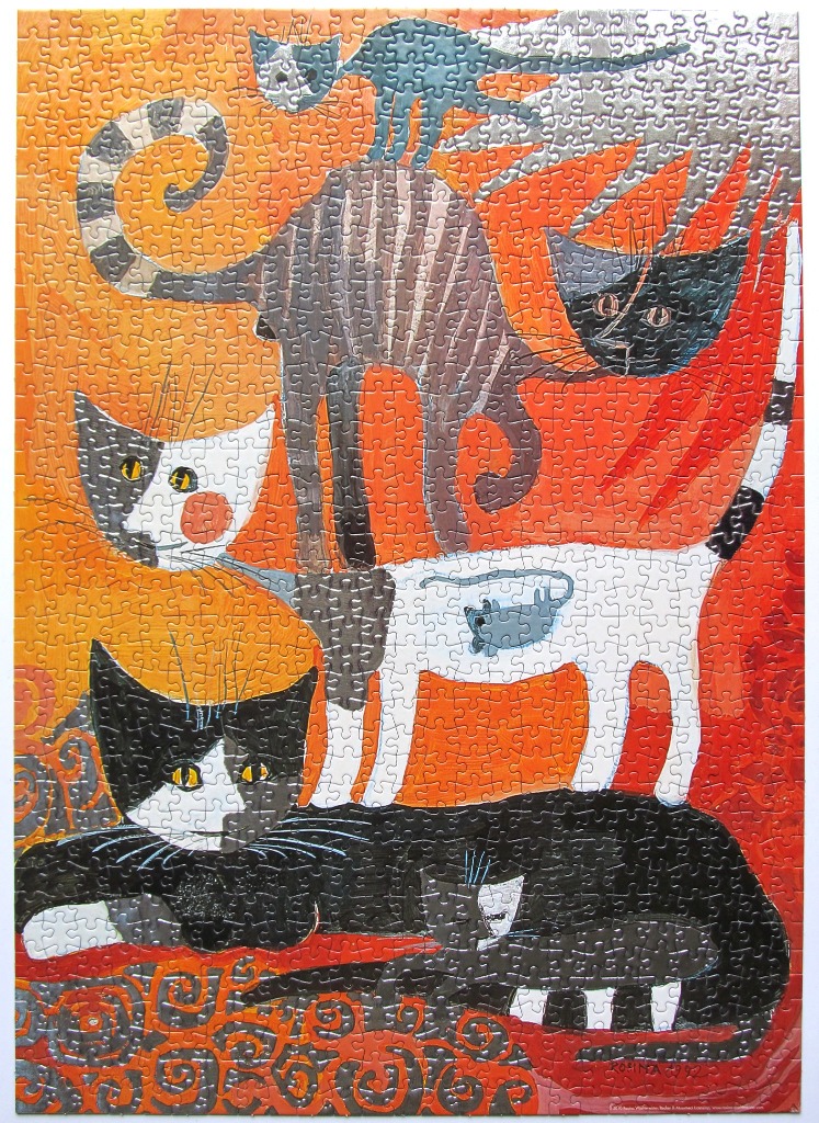A vibrant folk art illustration of seven stylized cats stacked and grouped against an orange and red background.