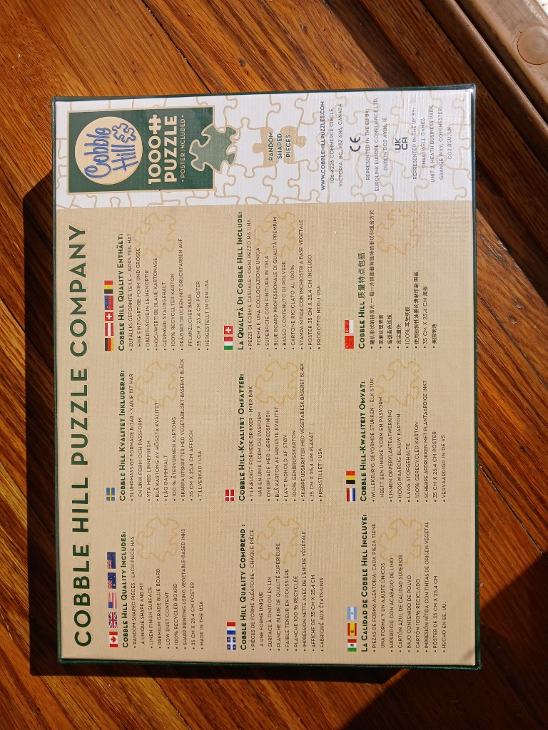 Puzzle box with green border, featuring brand logo, 1000+ puzzle text, and product details in multiple languages.