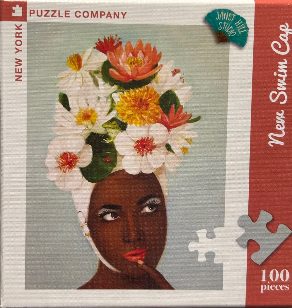 Portrait of a woman with a large, colorful floral headdress against a soft blue-grey background.