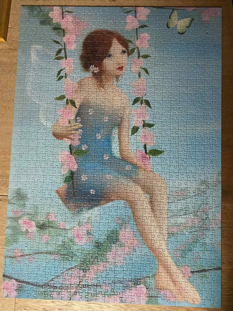 An illustration of a young woman with brown hair in a blue dress sitting on a swing amidst pink cherry blossoms.