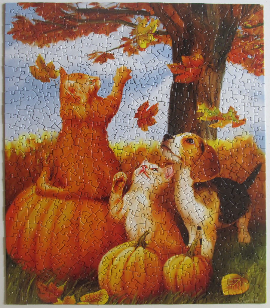 An orange cat and a beagle puppy playing with falling autumn leaves among pumpkins in a park.