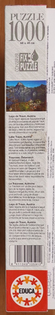Alpine lake with mountains, text in multiple languages.