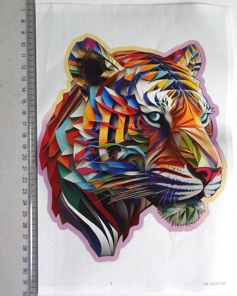 Stylized tiger head illustration made of overlapping geometric paper-like layers in vibrant colors.