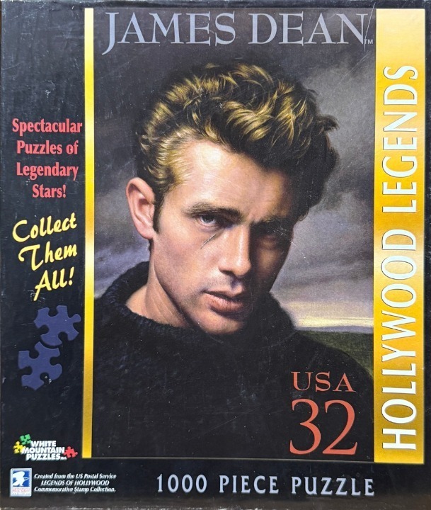 A portrait of James Dean in a black sweater against a dark, moody sky, designed like a commemorative postage stamp.