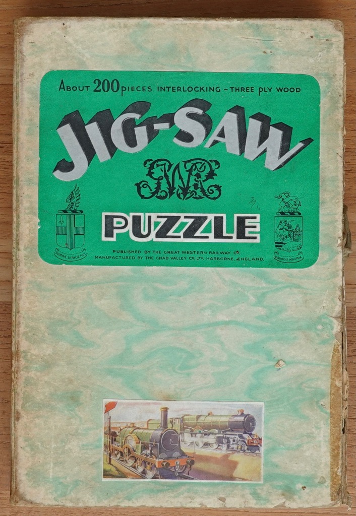 Vintage graphic design with a green panel, text, and an illustration of two classic steam locomotives.