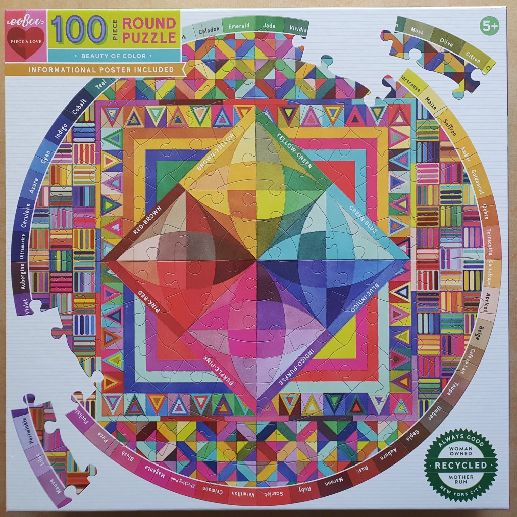 A round color wheel illustration featuring geometric patterns, gradients, and labeled color names around the border.