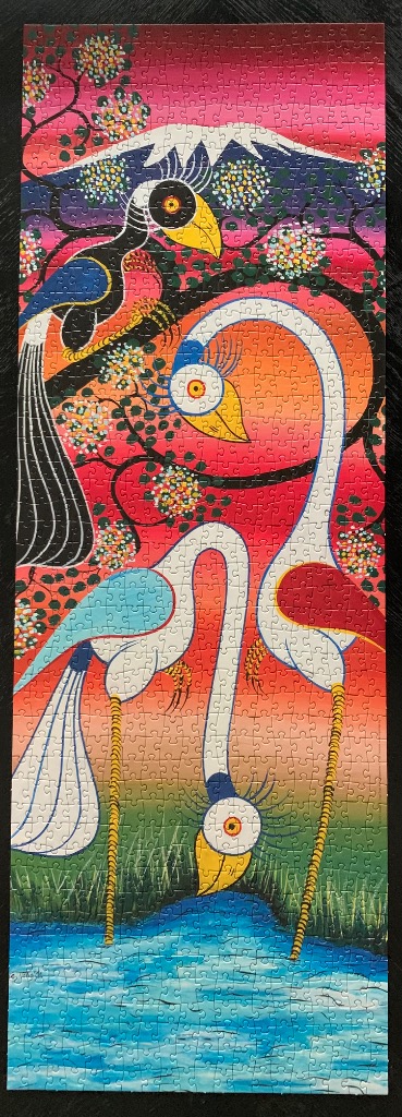 Stylized illustration of three exotic birds against a vibrant, multi-coloured sunset and a distant mountain peak.