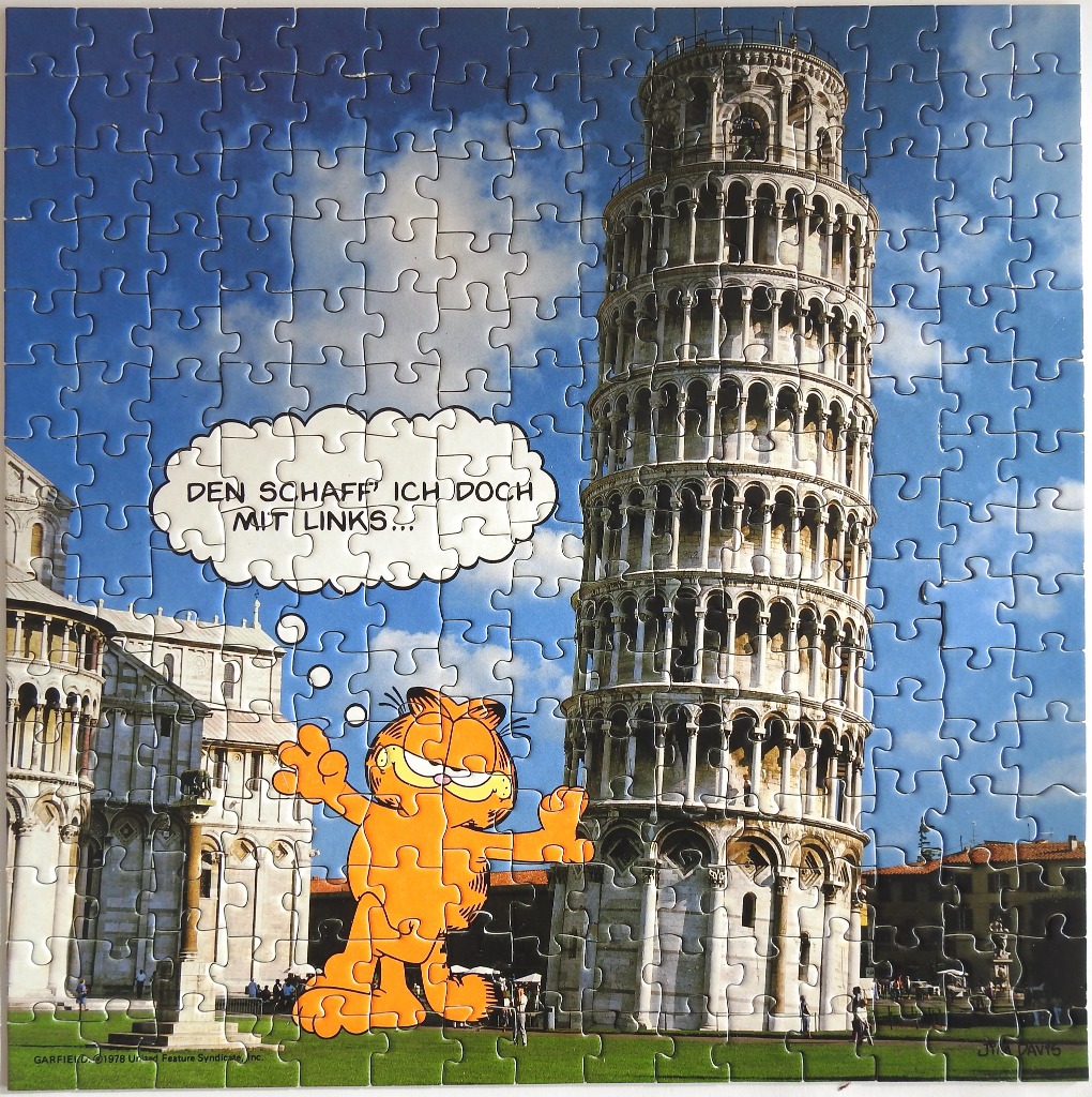 Garfield the cat standing in front of the Leaning Tower of Pisa
