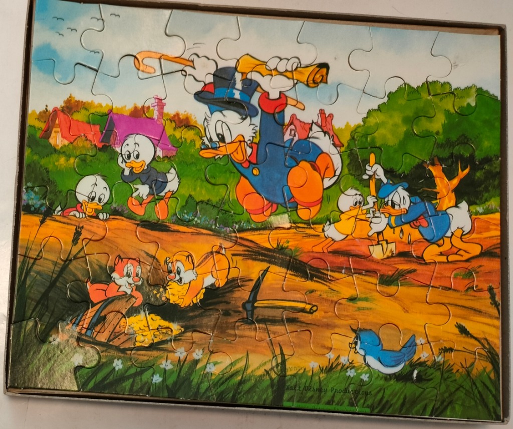 Vintage cartoon scene featuring Scrooge McDuck, Huey, Dewey, Louie, and Chip 'n Dale searching for gold.