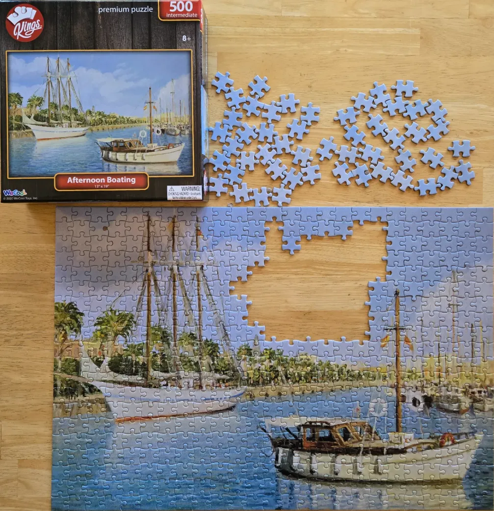 An oil painting style harbor scene featuring a large three-masted schooner and a smaller motor boat.