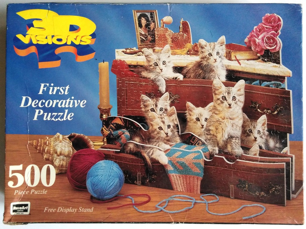 A group of six grey tabby kittens exploring a set of open wooden dresser drawers.