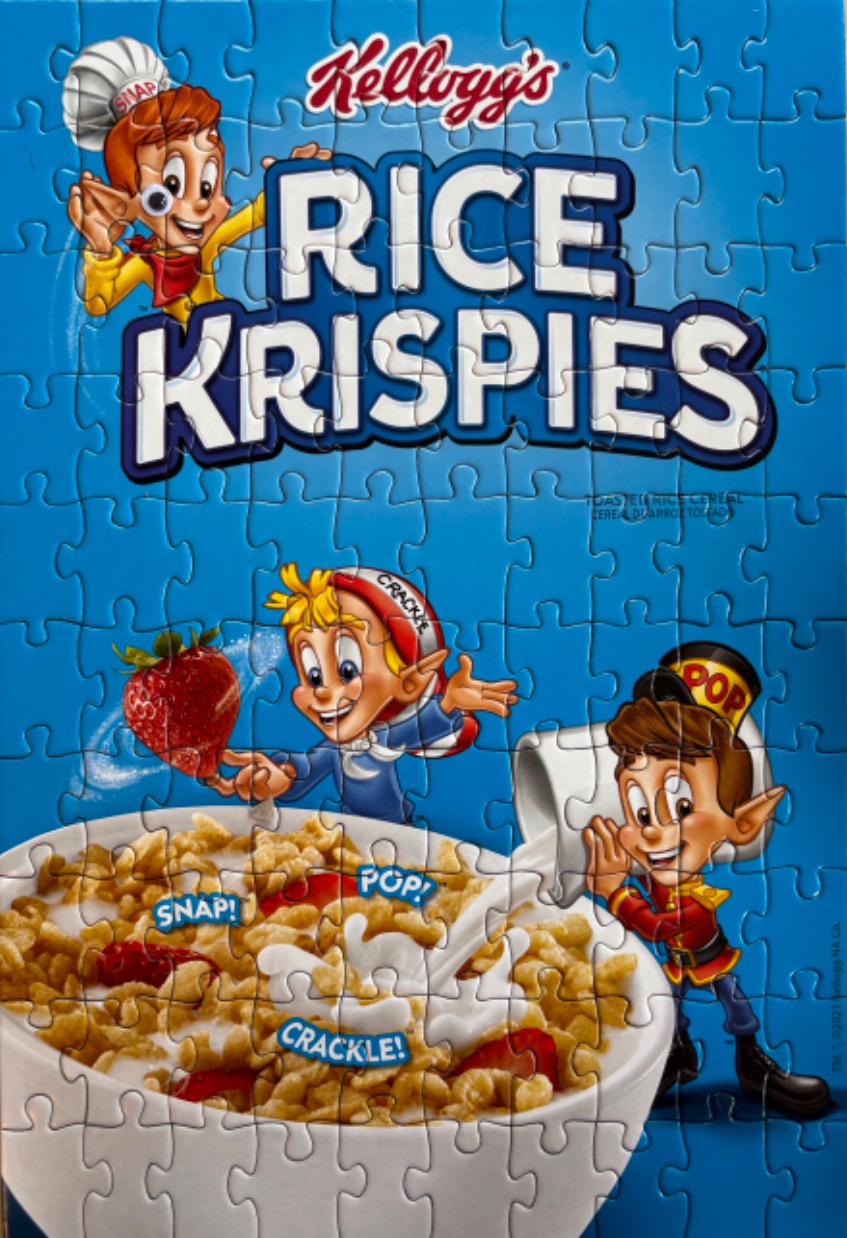 A classic cereal box illustration featuring three cartoon elves and a bowl of rice cereal with strawberries.