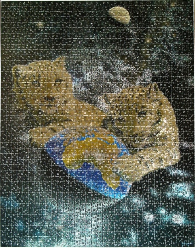Two leopard cubs sitting in outer space touching a small globe.