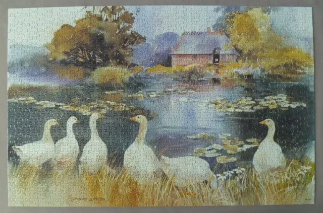 Watercolor painting of a flock of white geese standing on a grassy pond bank in front of a rustic cottage.