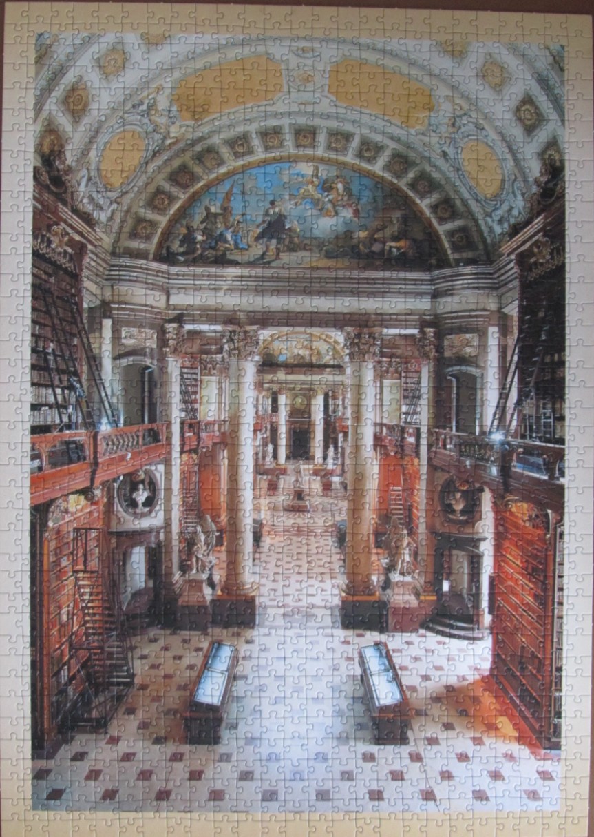 A wide-angle interior view of the grand, ornate Austrian National Library hall.