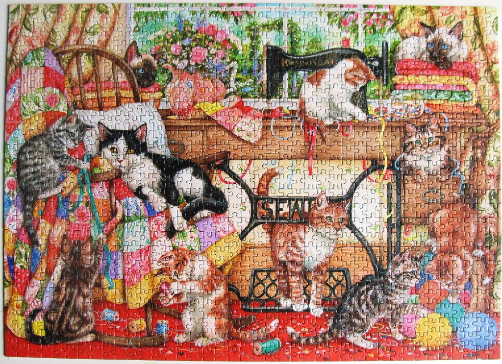 A whimsical illustration of many cats playing in a sewing room filled with fabric and vintage machines.