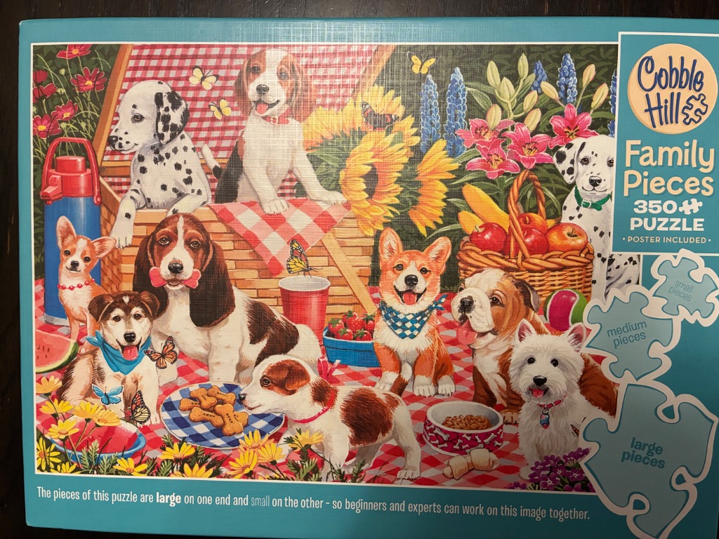 An illustration of ten various puppies having a picnic in a colorful garden.