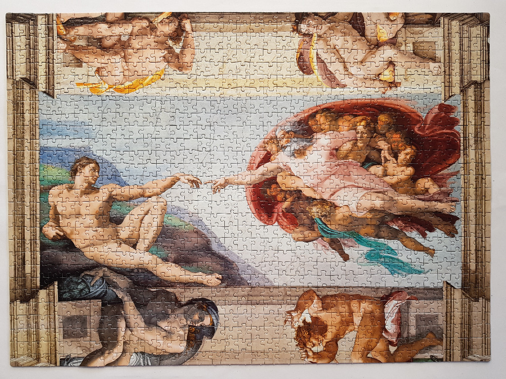 The Creation of Adam by Michelangelo, depicting God reaching out to touch Adam's finger.