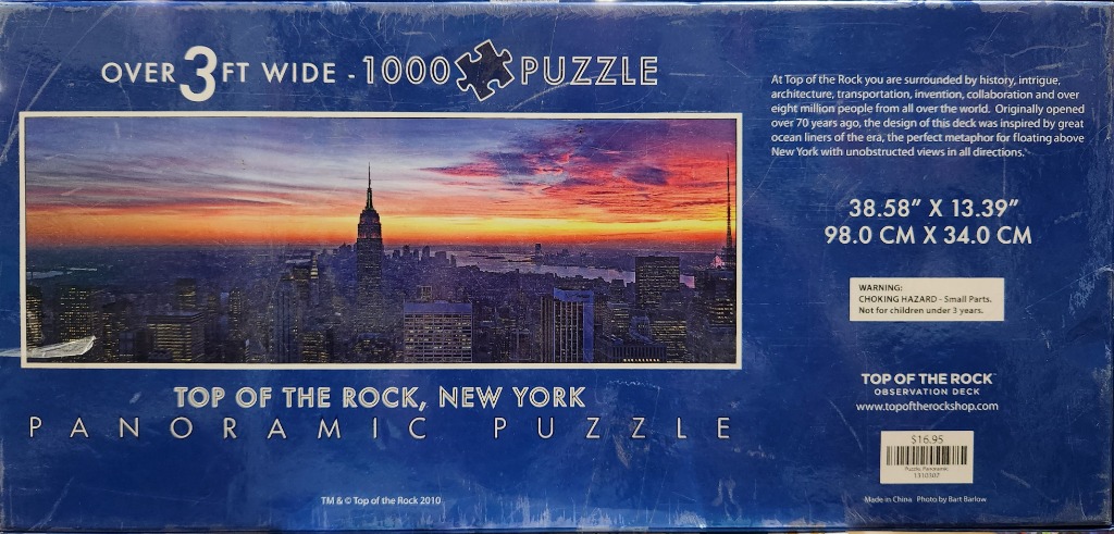 New York City skyline at sunset with Empire State Building. Vibrant orange and purple sky.