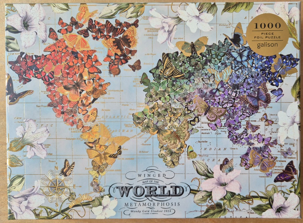A world map composed entirely of colorful butterflies against a pale blue background with botanical illustrations.